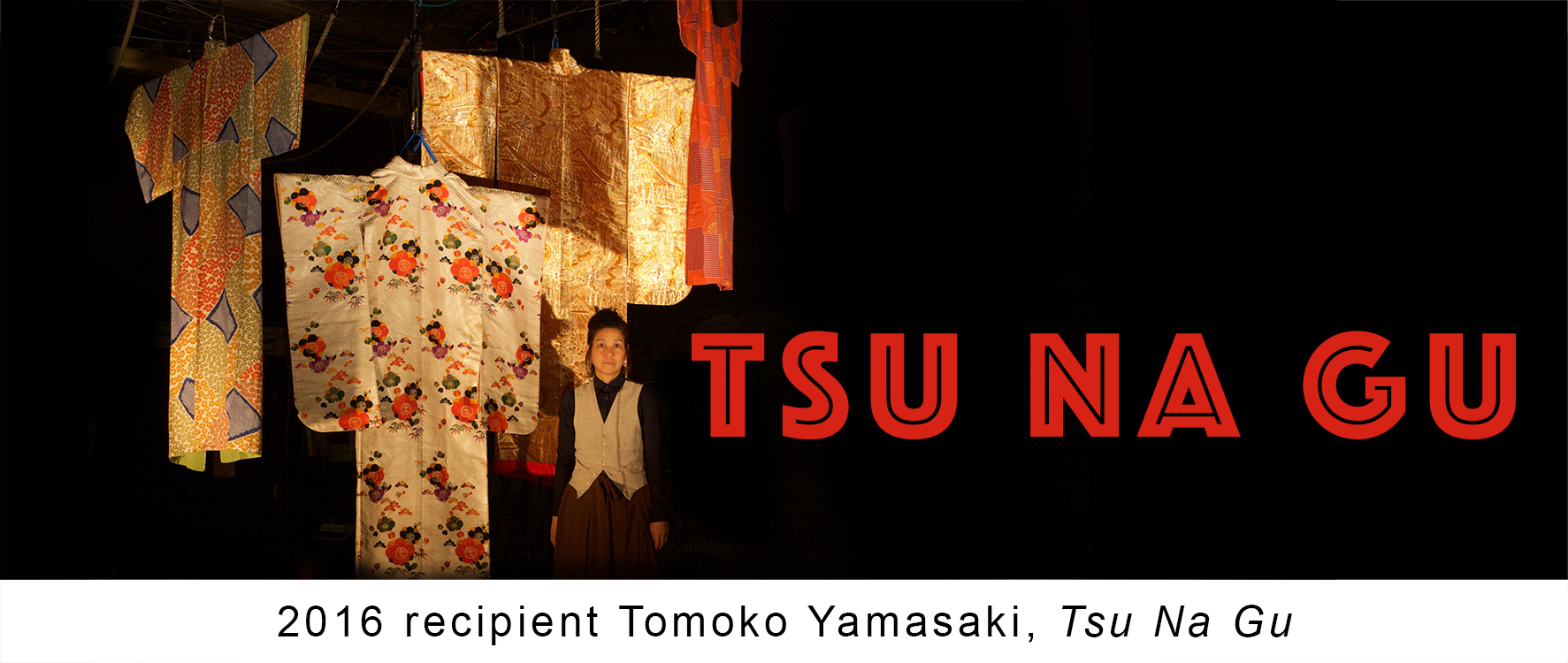 Tsu Na Gu promotional poster, featuring woman standing next by various fabrics.