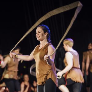A woman performing with fabric.