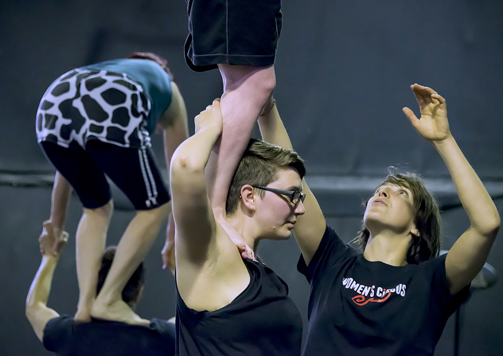 People in Women's Circus training space practicing acrobalance.