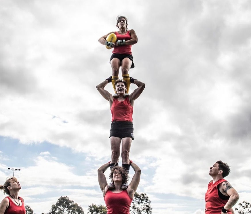 Flying Shot team doing three high acro stand